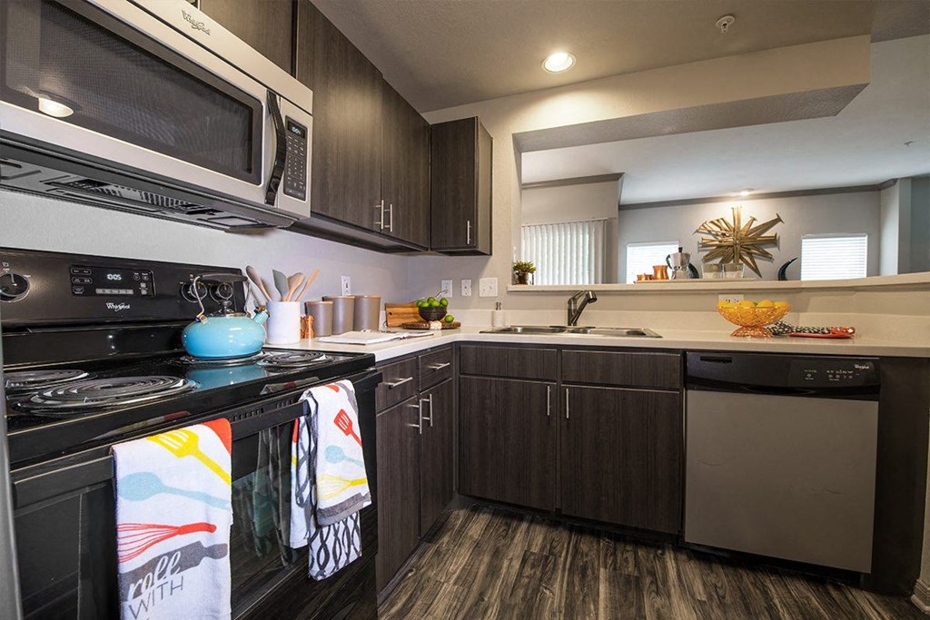 a kitchen with a stove microwave and sink