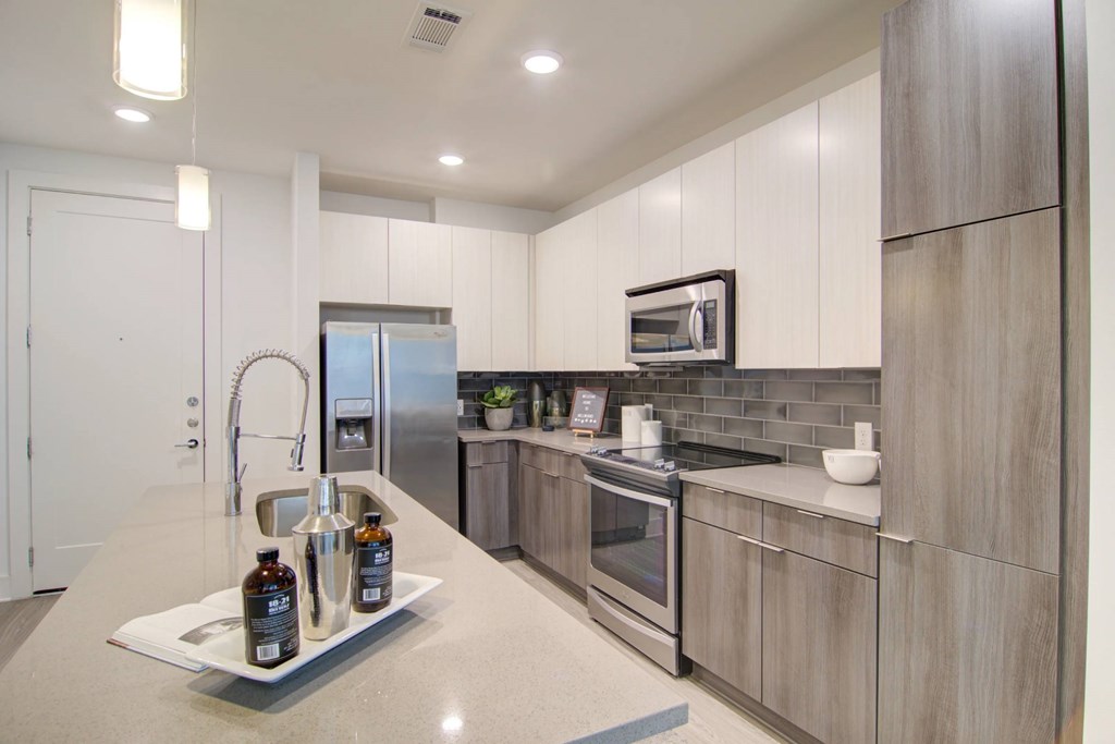 A kitchen with a white countertop and stainless steel appliances.