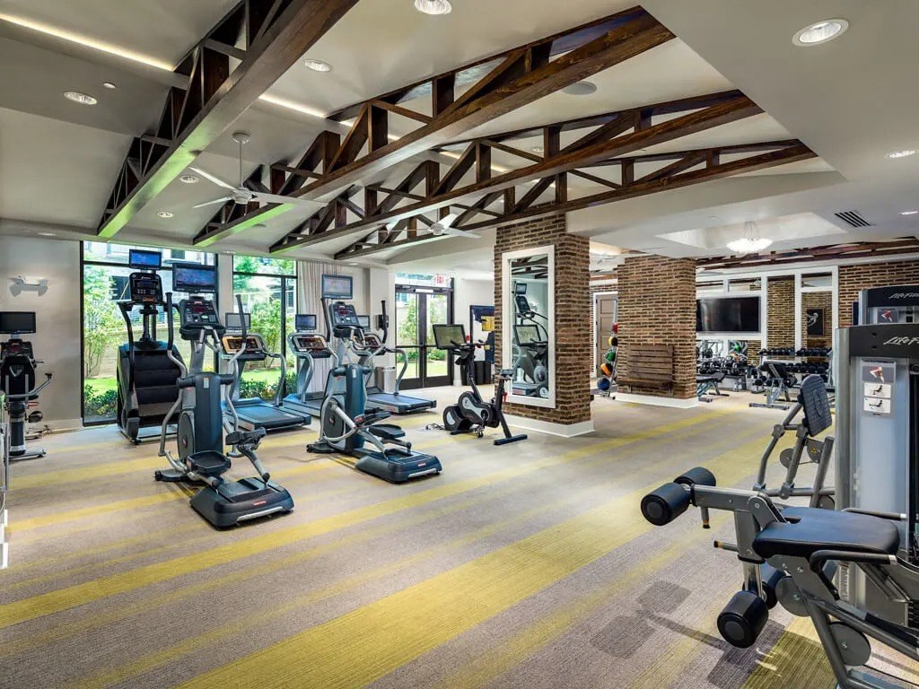 A gym with a variety of exercise equipment.