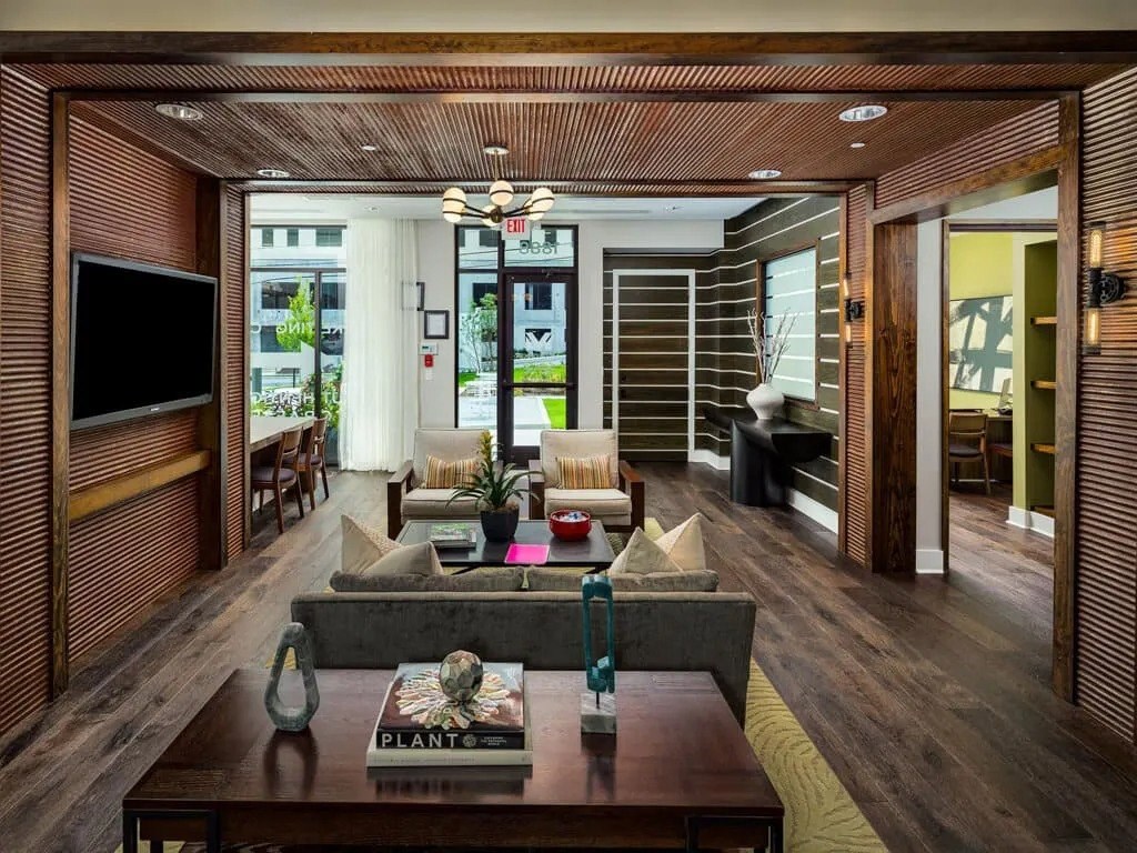 A living room with a wooden floor and a coffee table with a book on it.