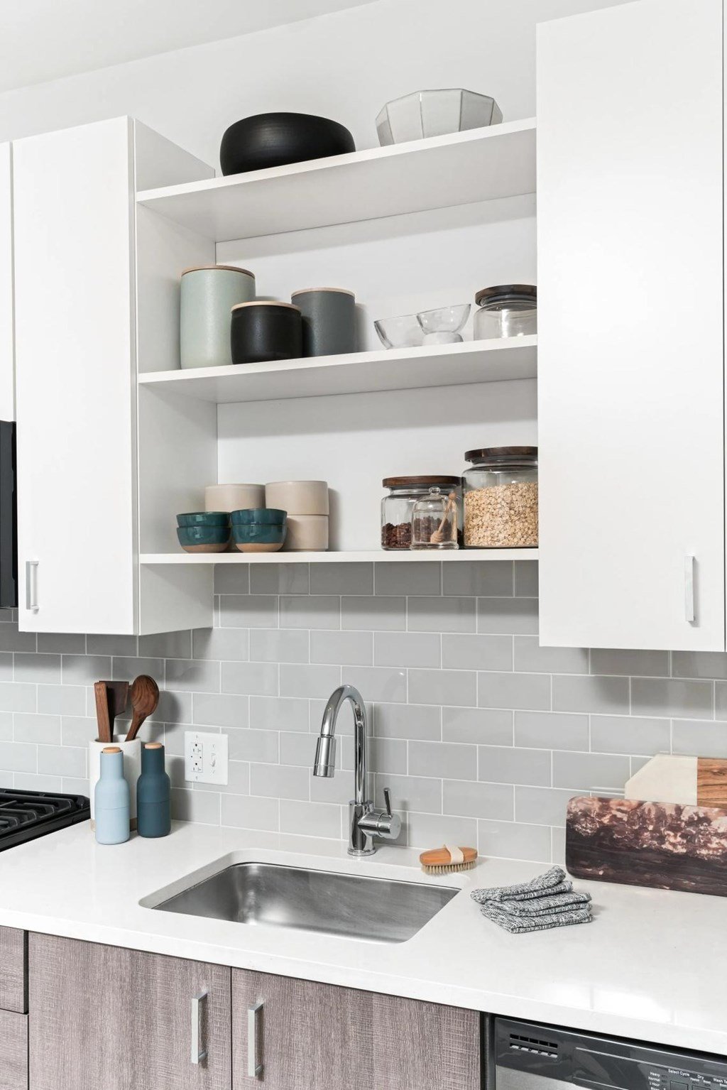 A kitchen with a white countertop and a white sink.