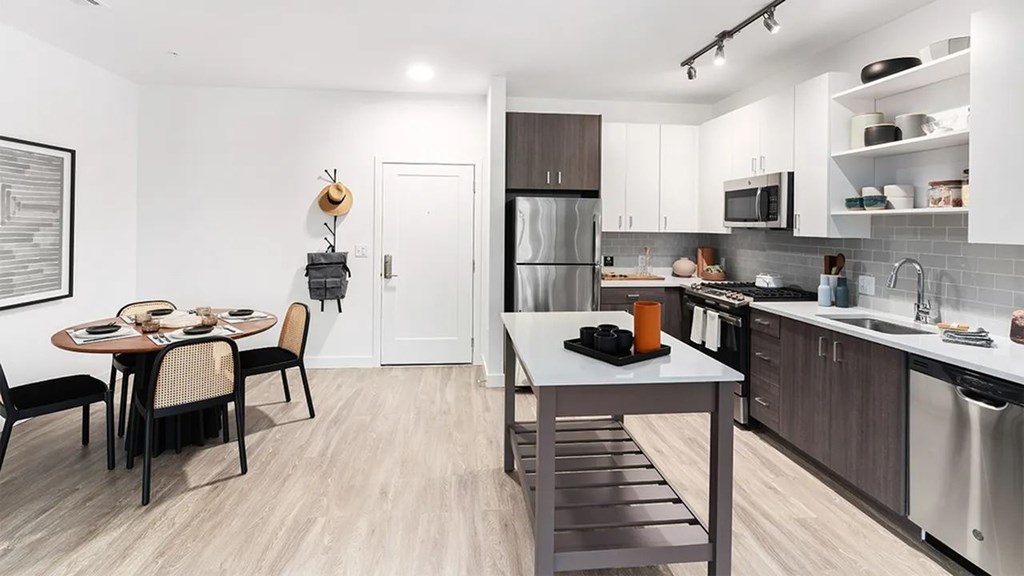 A modern kitchen with a dining table and chairs.