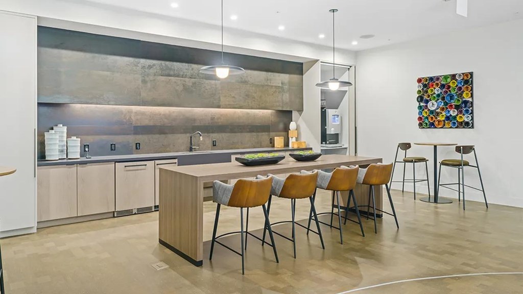 A modern kitchen with a dining table and chairs.