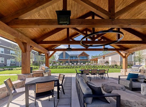 A wooden patio with a table and chairs.