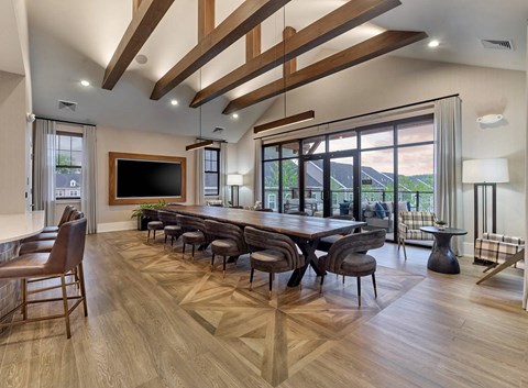 A modern dining room with a large wooden table and chairs.