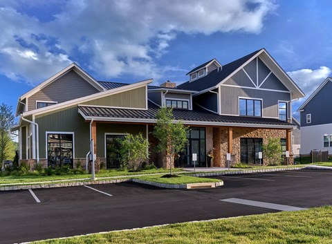 A modern building with a parking lot in front.
