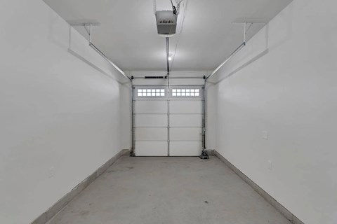 A white room with a door and a window.