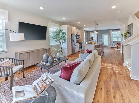 A modern living room with a grey sofa and a coffee table.