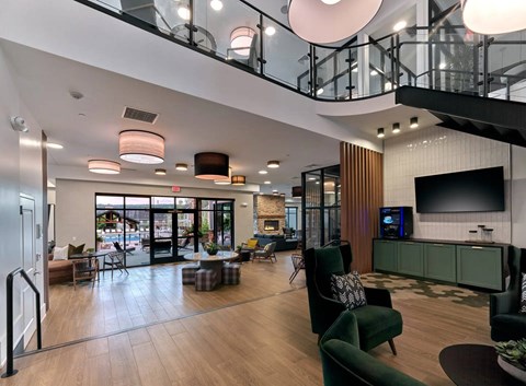 A modern living room with a green couch and a television.
