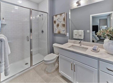 A bathroom with a toilet, sink, and shower.
