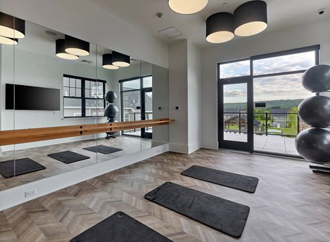 A spacious room with a bench, large windows, and a view of the outdoors.