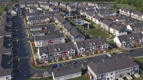 A bird's eye view of a residential neighborhood with houses and parked cars.