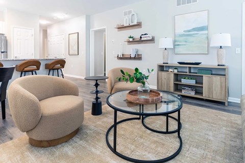 A living room with a glass table and a sofa.