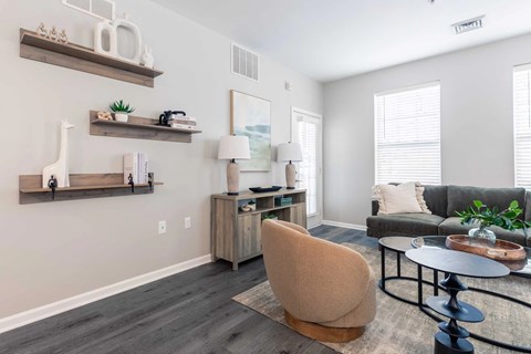 A living room with a chair, a table, and a couch.