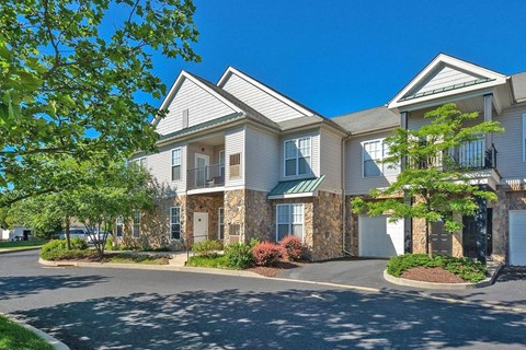 A large building with a green lawn in front.