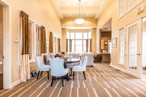 A dining room with a table set for four.