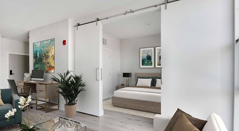 A modern bedroom with a bed, desk, and chair.