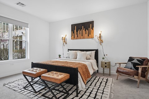 A bedroom with a large bed and a painting above it.