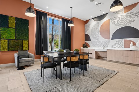 A dining room with a table set for four.