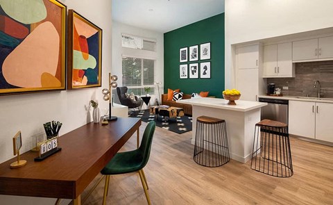 a living room with a table and a kitchen
