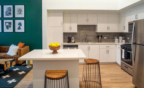 a kitchen with a white counter top and a refrigerator