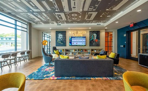 a living room with a couch and chairs and a television