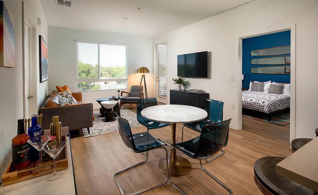 a living room with a table and a television