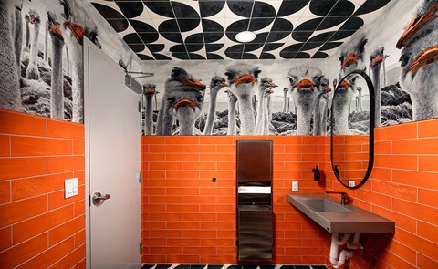 a bathroom with orange tiles and a shower and a sink