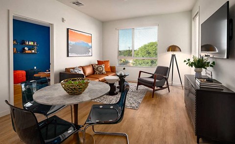 a living room with a table and chairs