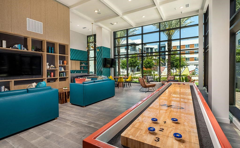 the lobby of a building with a large wooden table