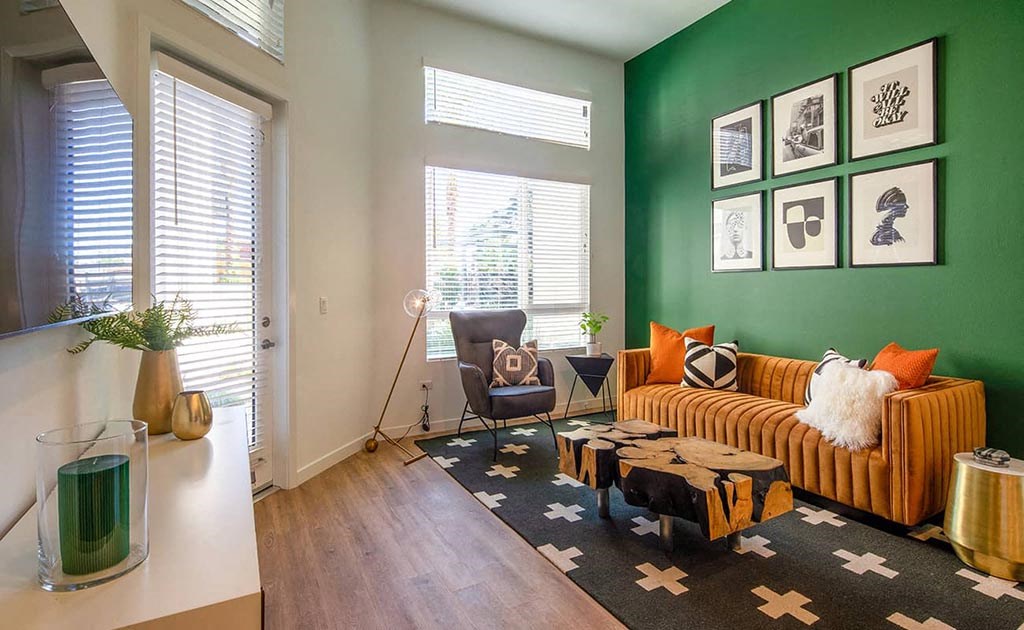 a living room with a couch and a green wall