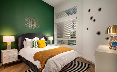 a bedroom with a bed and a green wall