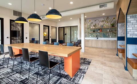 a dining room with a wooden table and chairs