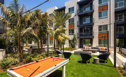 an apartment yard with a pool table and a ping pong