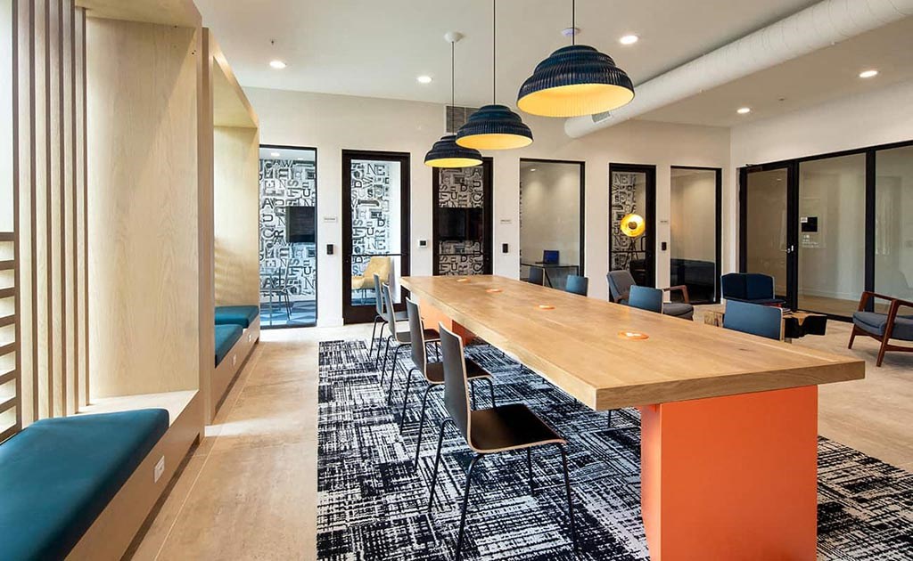 a long communal table in a room with chairs