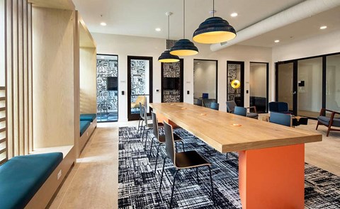 a long communal table in a room with chairs