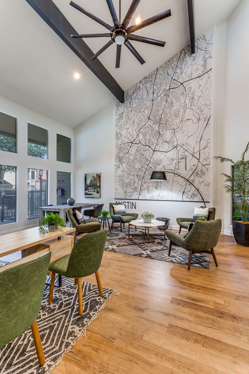 a living room filled with furniture and a large painting on the wall