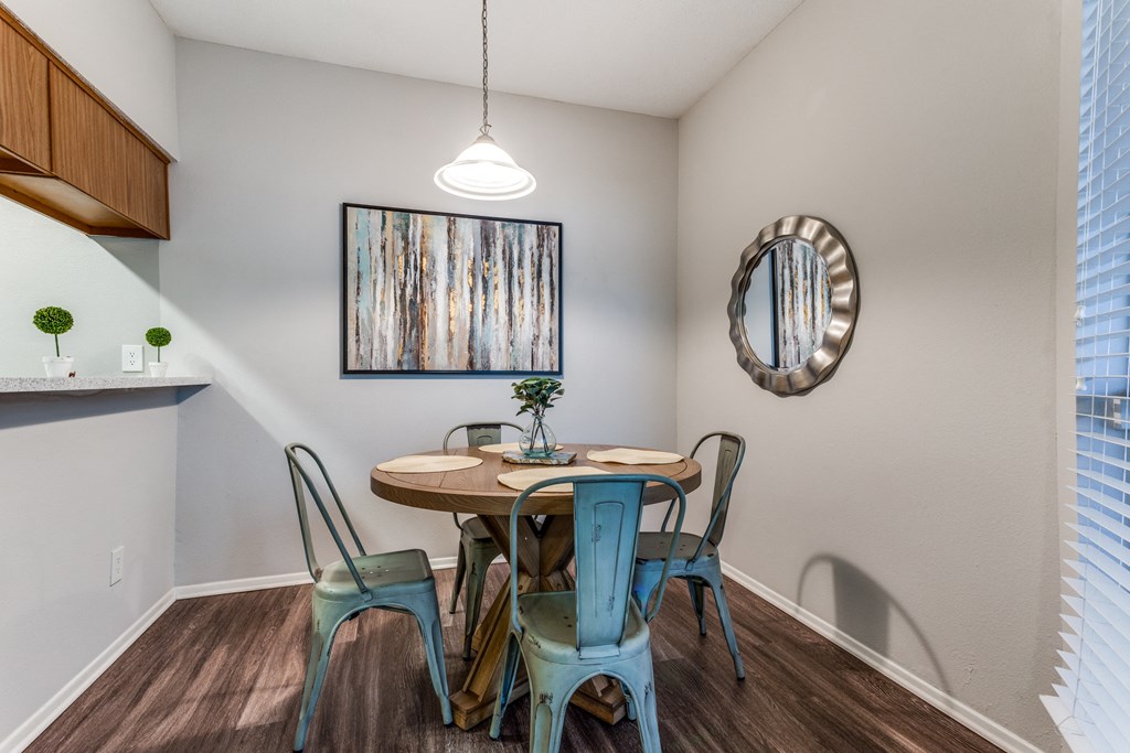 a dining area with a table and four chairs
