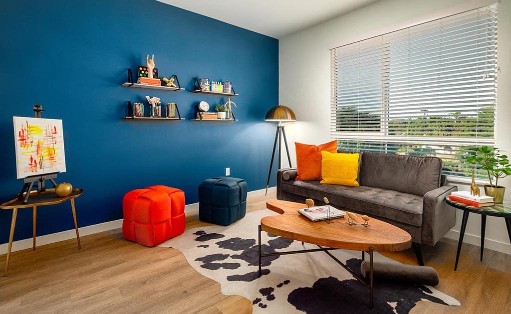 a living room with a blue wall and a couch