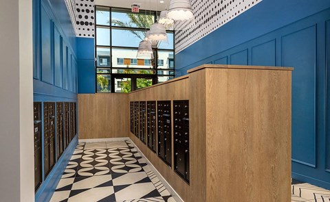 a hallway with a wall of wine racks and a checkered floor