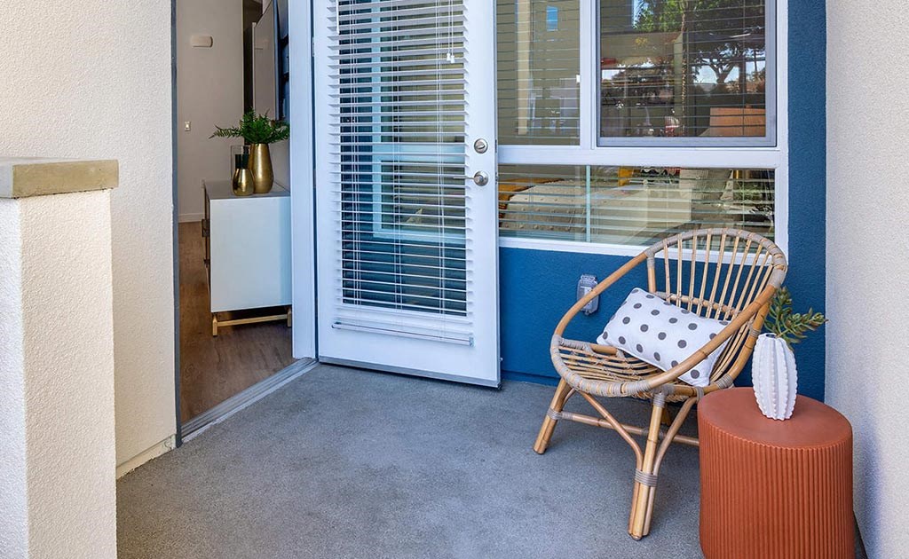 a chair sitting on a porch next to a door