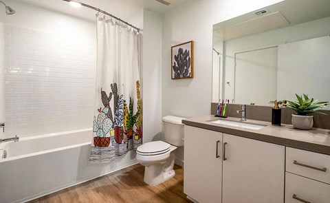 a bathroom with a toilet and a sink and a bath tub