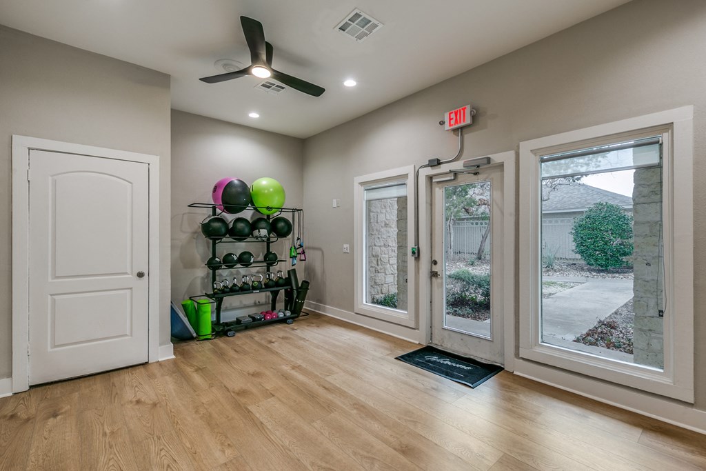 a living room with two windows and a door and a ceiling fan at Canyon Ridge, Austin, TX, 78753