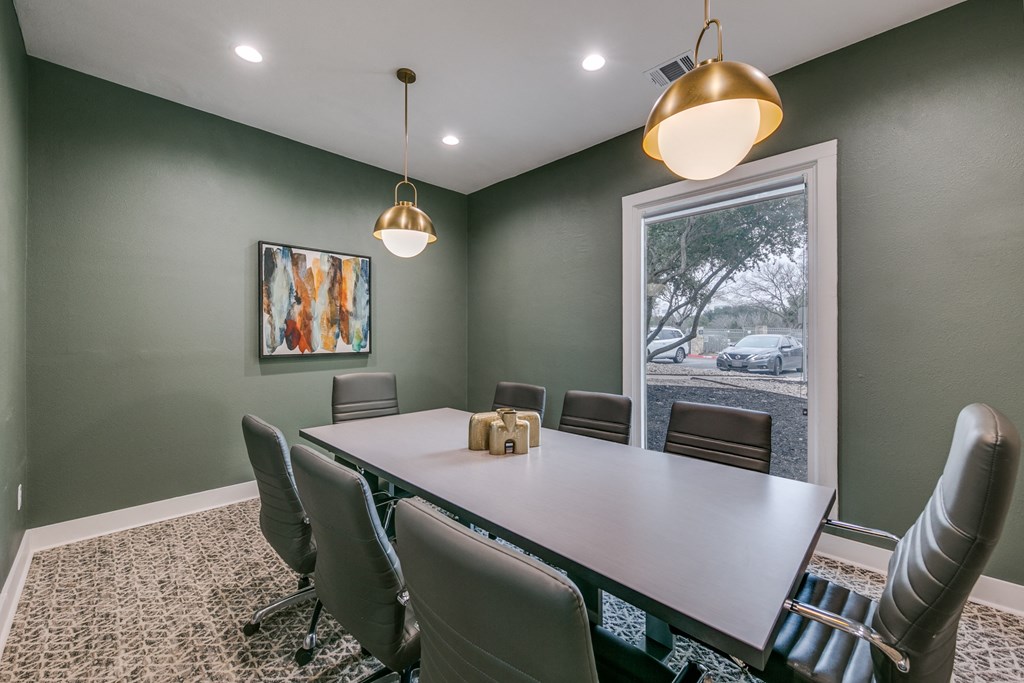 a conference room with a table and chairs and a window at Canyon Ridge, Texas
