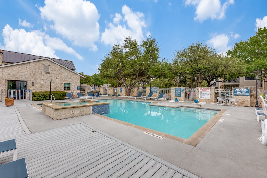A large outdoor swimming pool at Canyon Ridge, Austin, TX, 78753 surrounded by a deck.