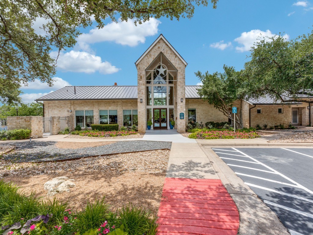 A building with a red pathway leading to the entrance.