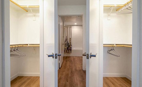 a room with a closet and a hallway with a door