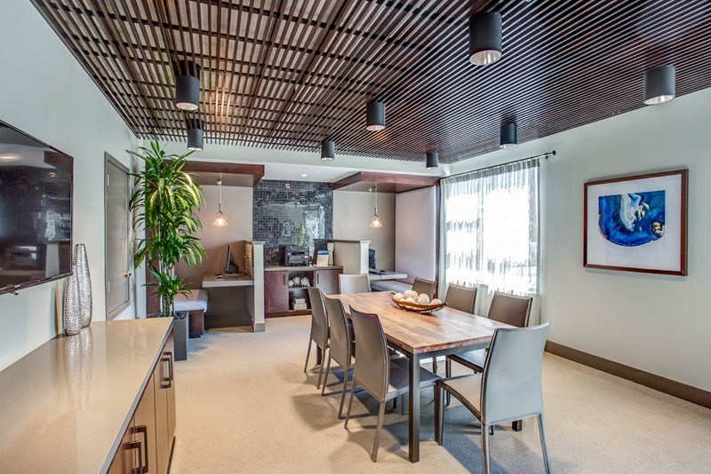 a dining room with a wooden table and chairs