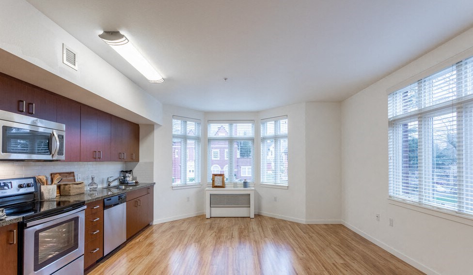 a kitchen with a stove top oven next to a window