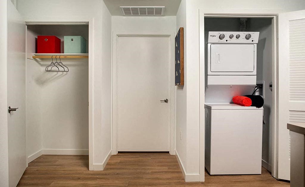 a kitchen with a washer and dryer and a closet